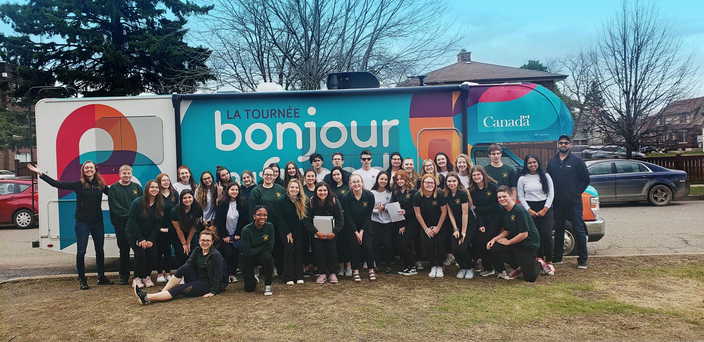 Group of students in front of Bonjour my friend’s caravan